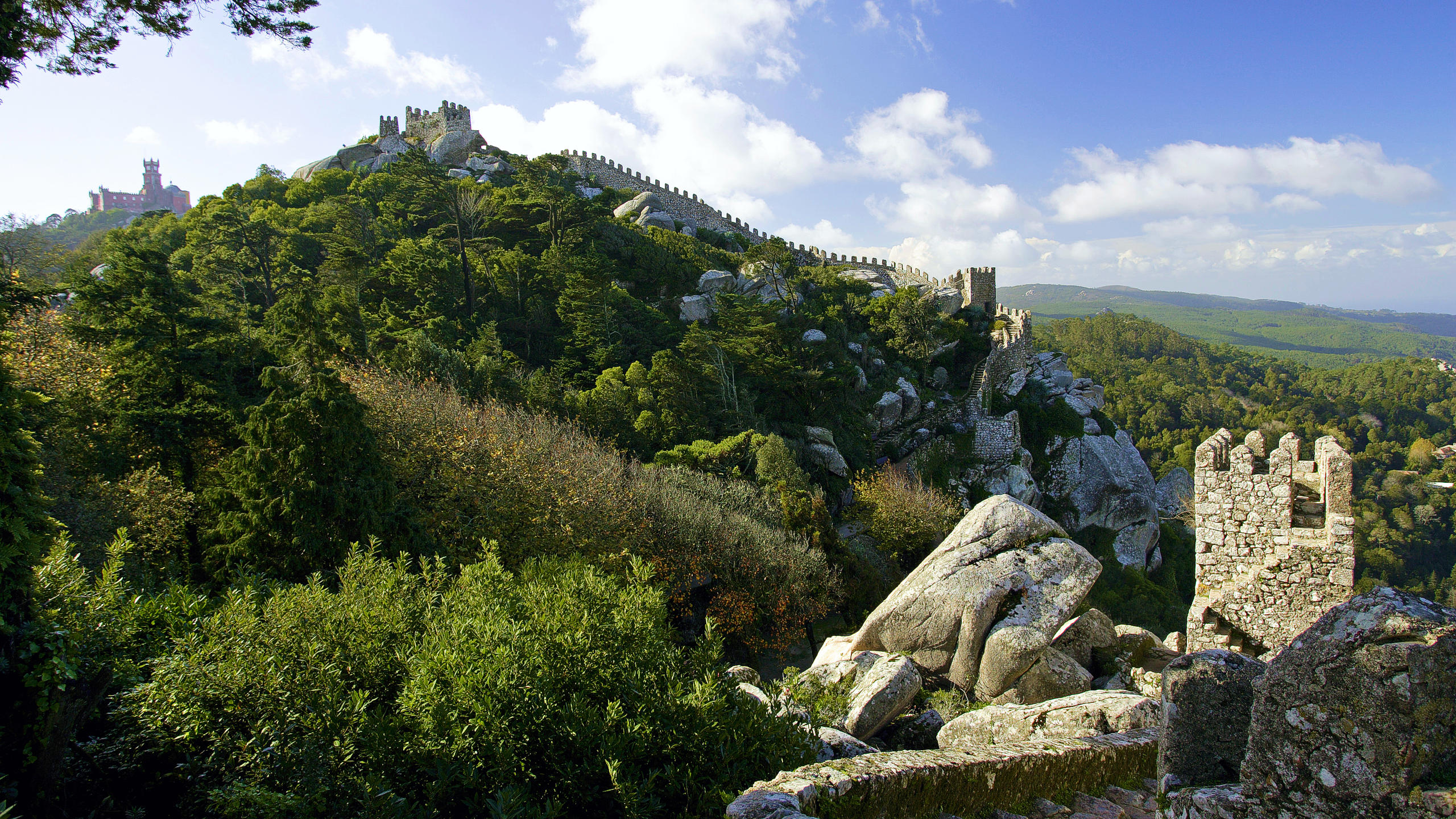 Walls of the Castle of the Moors with the Pena Palace in the background on the left